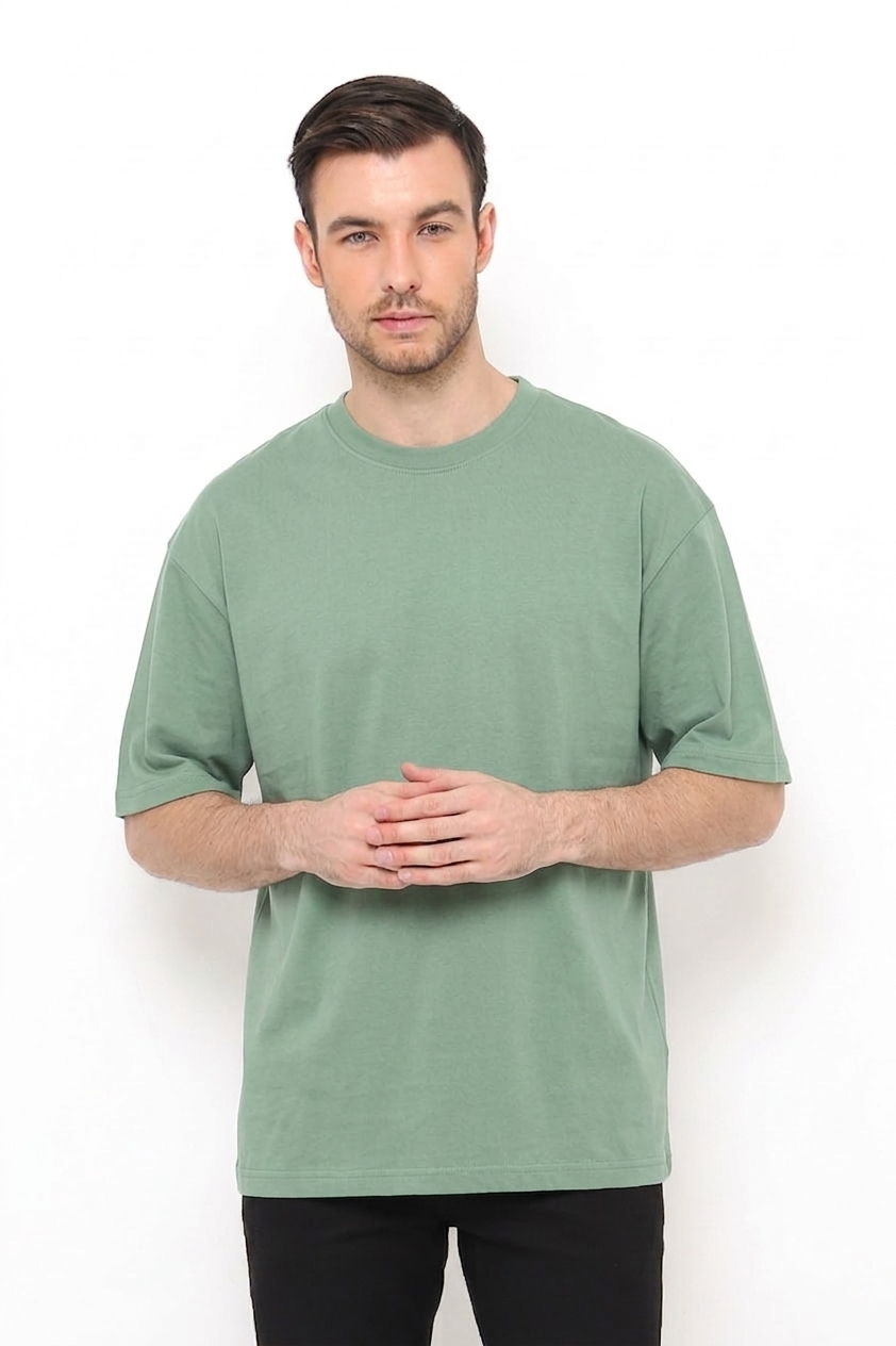 Model wearing a sage green oversized cotton t-shirt